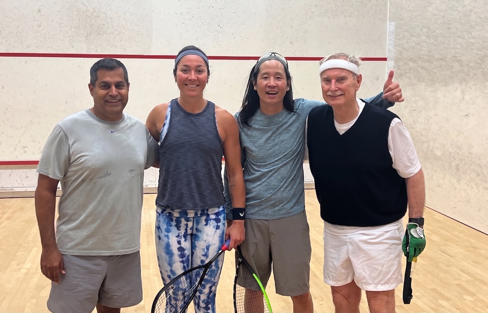 Squash players together on the court after a match