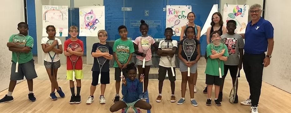 Squash Rocks youth program participants holding racquets